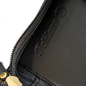 Pelikan logo impressed on leather.